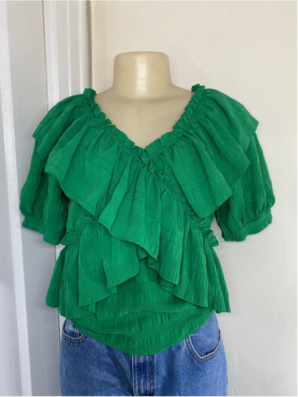 Green ruffle blouse with subtle grid texture